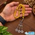 خرید تسبیح عقیق زرد شرف الشمس ۳۳ دانه‌ای از گوهر فردوس ایران